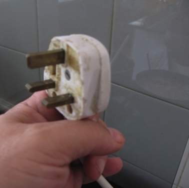 Old plug, not because its dirty, it does not have insulation on positive and negative prongs.