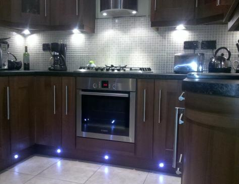 New build kitchen with decorative under cabinet halogen lights and decorative LED plinth lights