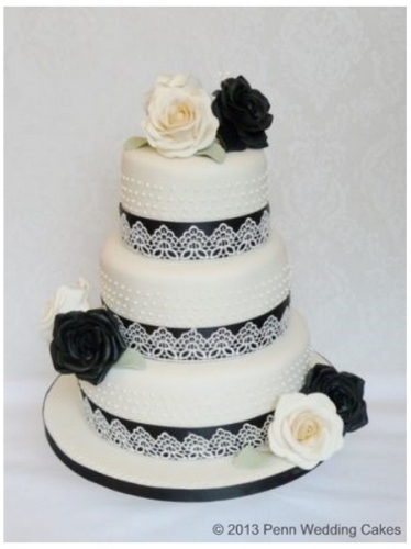 3 tier wedding cakes with ivory and black roses